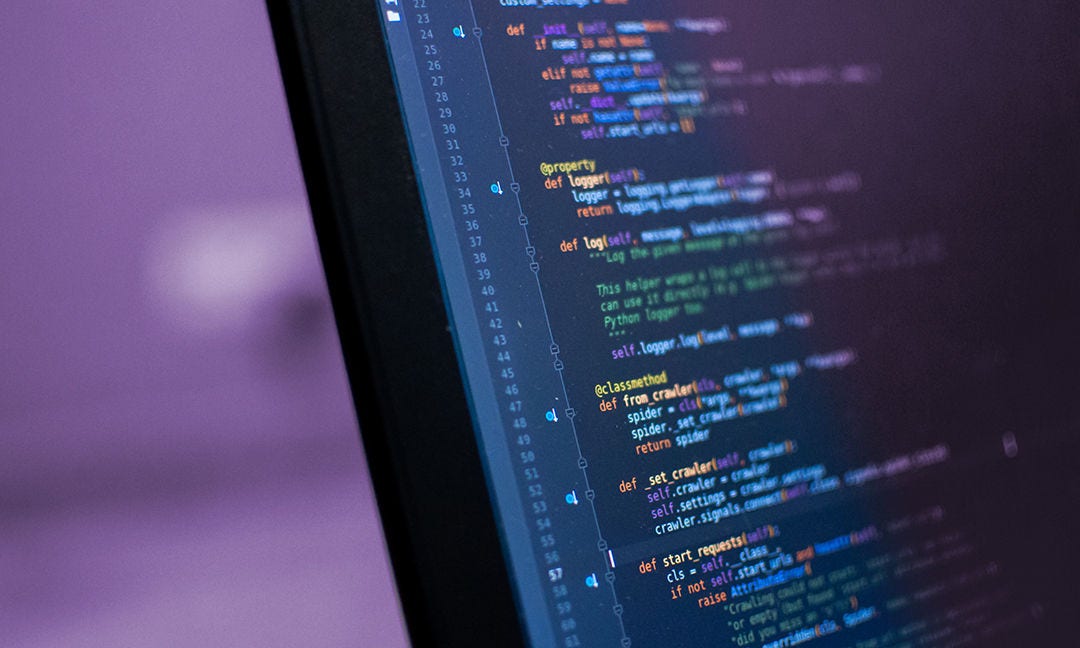 Programmer coding python, java script, html code on notebook screen at home. Work from home. Working process illustration for business.